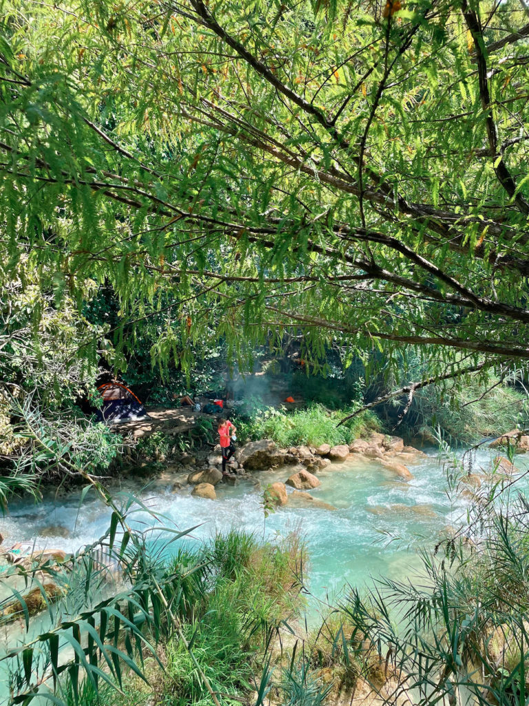 People camping on the banks of the river at El Chiflon. 